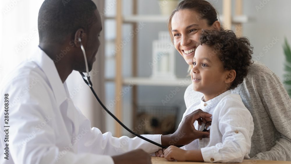 A doctor is examining a child 's heart.