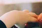 A person 's hand on the computer keyboard.
